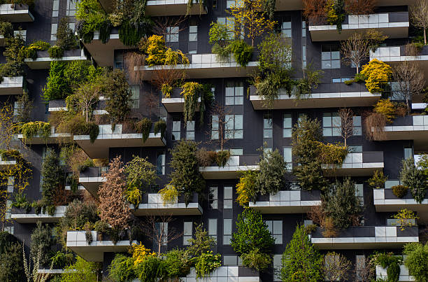 istock Green building with trees represents modern architecture in Milan. Vertical forest building. Bosco Verticale skyscraper. Sustainable architecture. Vertical forest tower in Italy. 2244189950