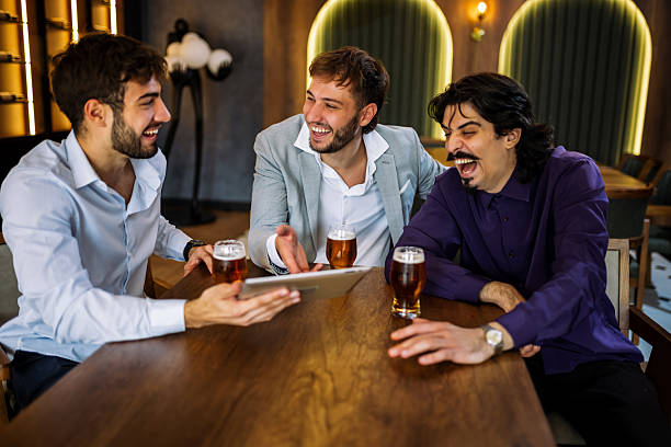 istock Colleagues discussing work over beer in restaurant 2244191026