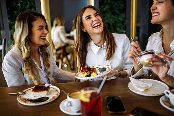 istock Three women enjoying cakes in restaurant after shopping 2244191161
