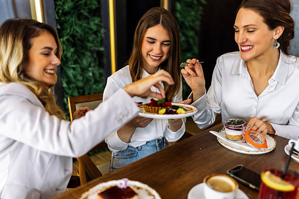 istock Three women enjoying cakes in restaurant after shopping 2244191219