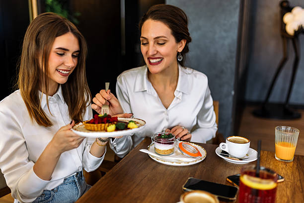 istock Three women enjoying cakes in restaurant after shopping 2244191222