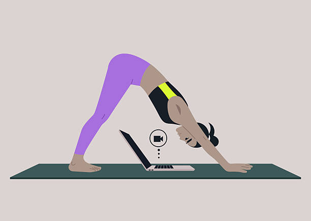 istock Work life balance, Practicing the inverted V yoga pose on a mat, this scene blends fitness and office responsibilities as a person connects with their laptop 2244191380