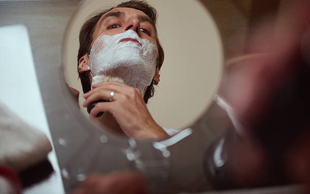 Man Shaving in Mirror With Foam Beard, Close-Up View and Quiet Morning Routine