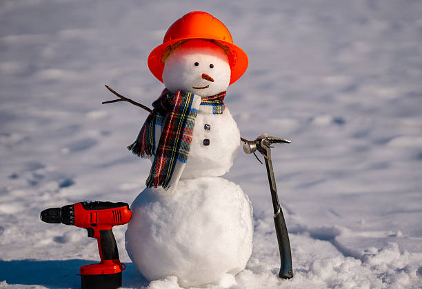 istock Snowman builder promotes hardware store tools. Hardware store in winter. Cute snowman advertises seasonal hardware sale. 2244194942