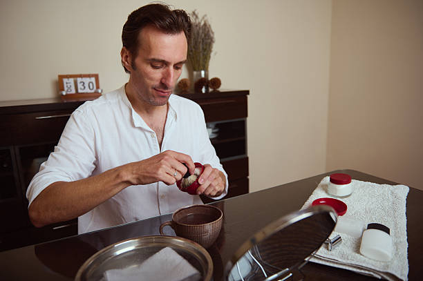 istock Man Preparing Grooming Kit At Desk With Shaving Accessories 2244195141