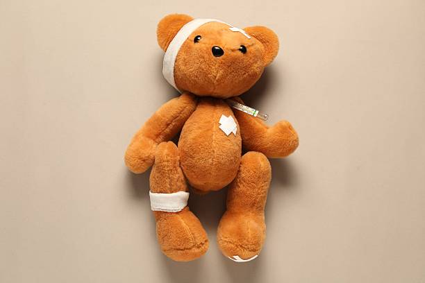 Teddy bear sitting at table and pediatrician in the background
