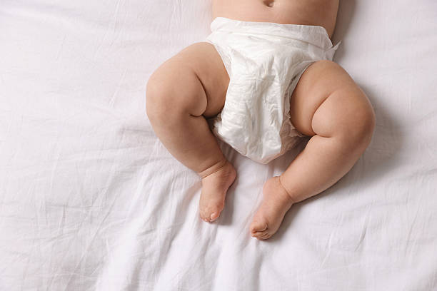 istock Cute little baby in diaper on bed, top view 2244198237
