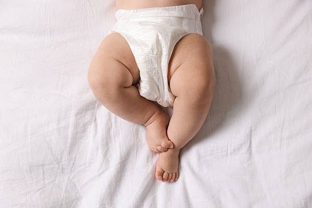 istock Cute little baby in diaper on bed, top view 2244198239