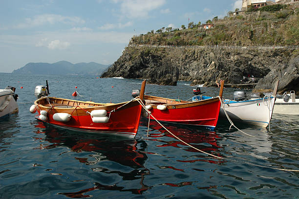 Fishing boats moored in the harbor of Riomaggiore, one of 5 villages of Cinque Terra in Tuscany