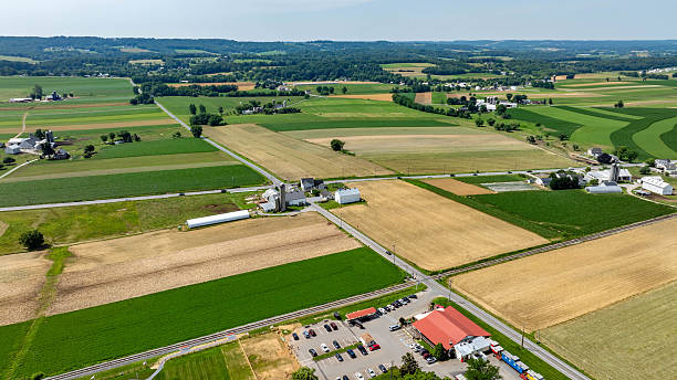 istock Scenic Farmland Landscape With Fields and Rural Structures Under a Clear Blue Sky 2244202551