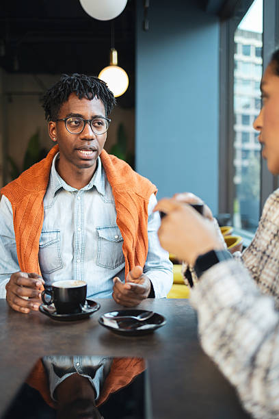 istock Young black man talking during coffee shop meeting 2244202749