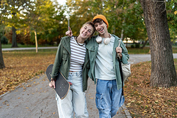 istock Happy young couple walking in autumn park 2244203737