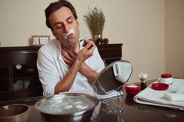 istock Man Shaving at Home With Razor, Foam, and Mirror During a Calm Morning Routine 2244204863