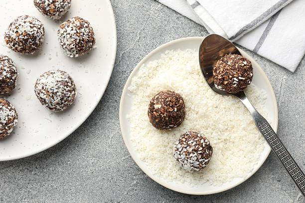 istock Making tasty chocolate candies with coconut flakes at grey table, flat lay 2244205653