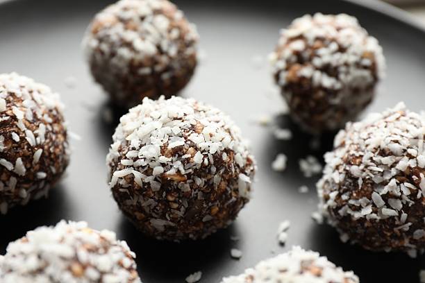 istock Tasty chocolate candies with nuts on plate, closeup 2244205654