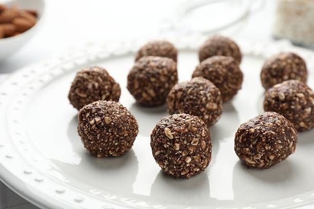 istock Tasty chocolate candies with nuts on white table, closeup 2244206049