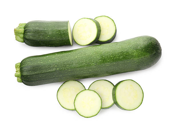 istock Whole and cut fresh zucchinis isolated on white, top view 2244207266