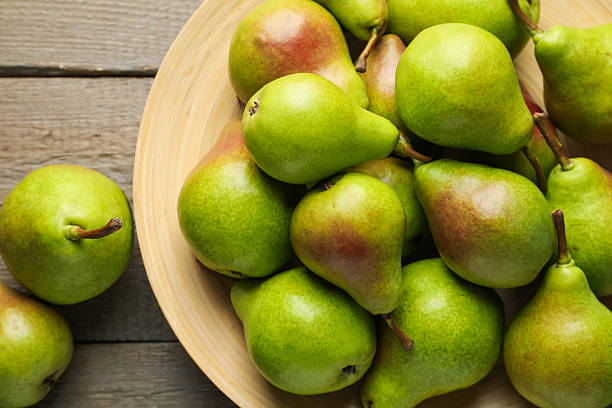 istock Fresh ripe pears on wooden table, flat lay 2244208724