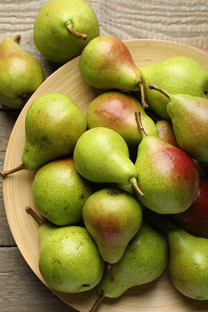 istock Fresh ripe pears on wooden table, flat lay 2244208761