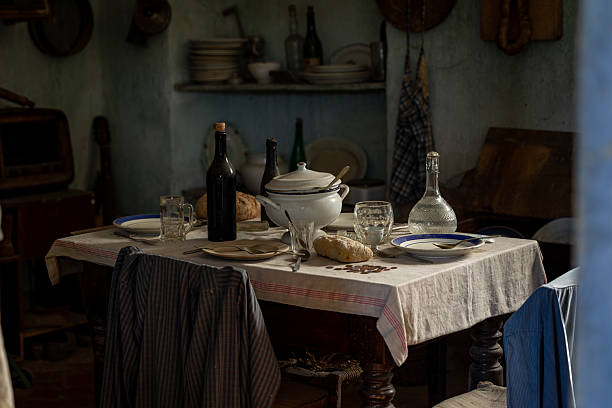 Rustic Vintage Kitchen Table with Traditional Dining Setup and Ceramic Dishware in Old Farmhouse Interior