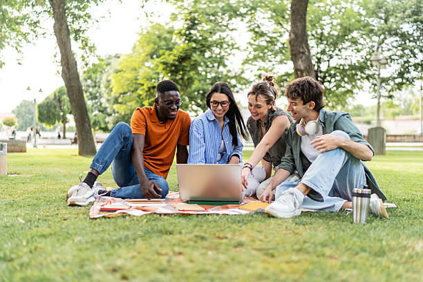 istock University students collaborating on laptop outdoors in park 2244210350