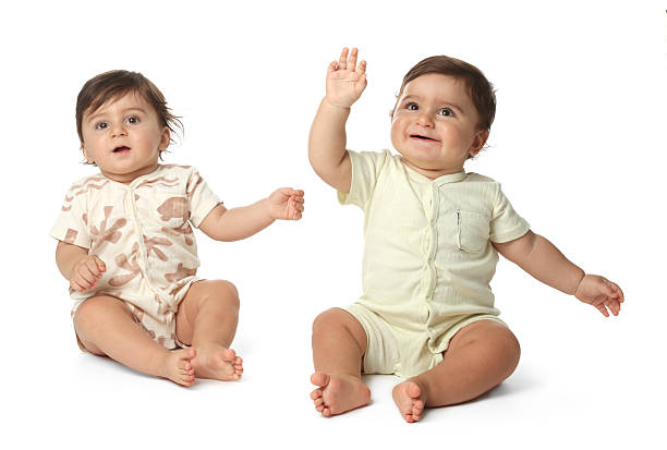 istock Cute little twin babies on white background 2244210510