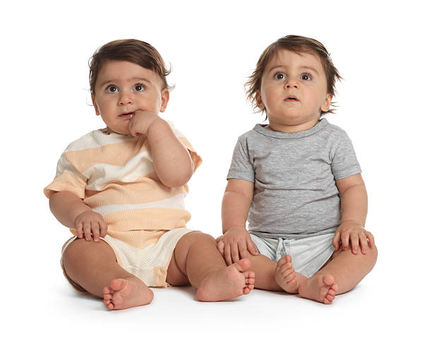istock Cute little twin babies on white background 2244210561