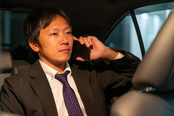 istock Businessman proceeding with a client talk in the car 2244210633