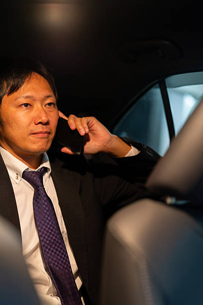 istock Businessman proceeding with a client talk in the car 2244210663