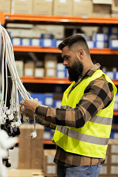 Employee sorting wire products in warehouse