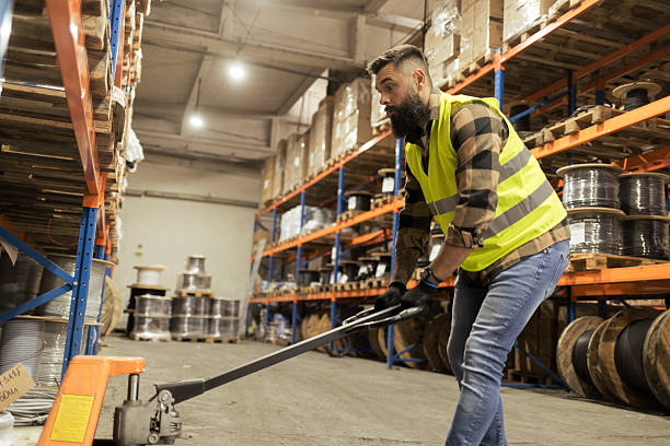 istock Worker transporting goods with pallet truck 2244211060