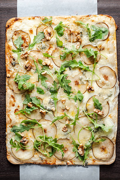 Gourmet flatbread pizza with pear gorgonzola and arugula