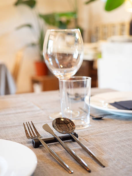 istock Restaurant table setting with modern cutlery and glasses 2244211839