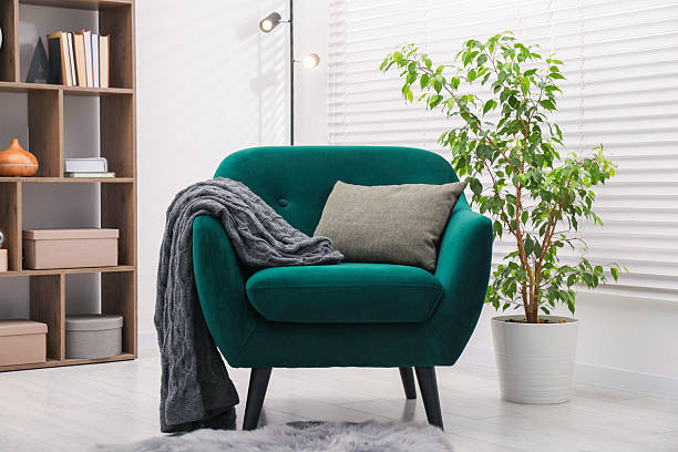 istock Stylish armchair with pillow and blanket indoors. Interior design 2244211907