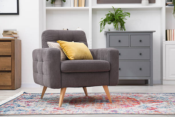 istock Grey armchair with pillows indoors. Interior design 2244211909