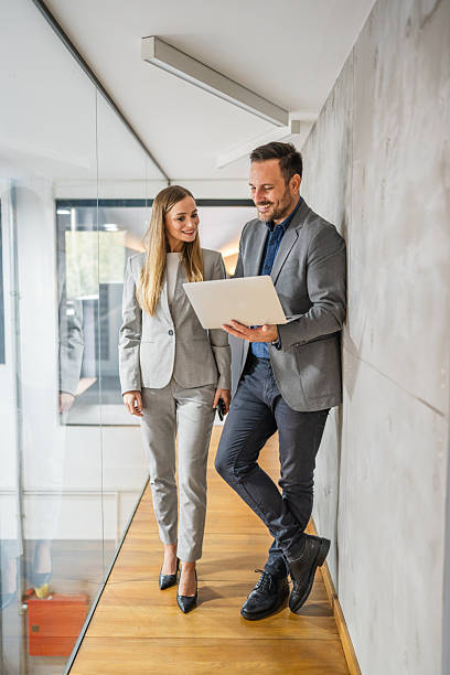 istock Business colleagues discussing project while looking at laptop 2244212231