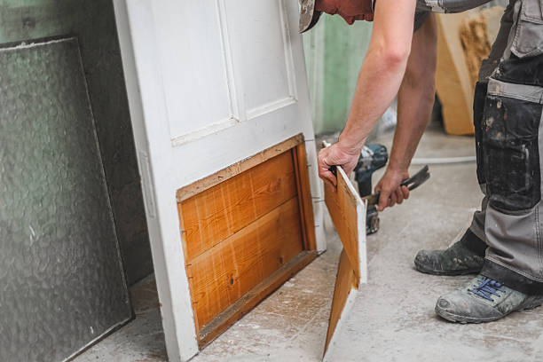 istock One carpenter dismantled an old door by himself using a crowbar. 2244212495