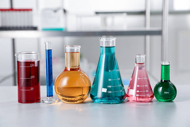istock Different laboratory glassware with color liquids on light table indoors 2244212505