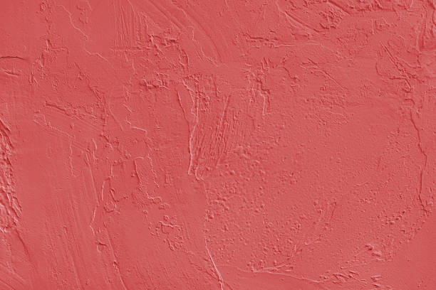istock Close up red colored painted plaster wall surface background with rough brushstrokes texture 2244212542