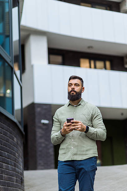 istock Entrepreneur walking outside and texting on phone 2244215032