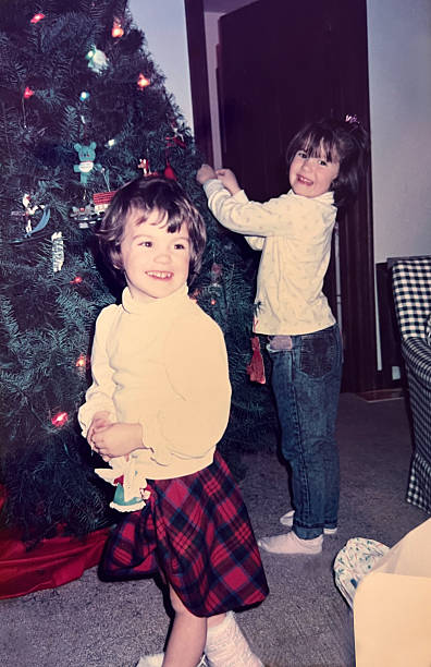 istock Girls Decorating Christmas Tree 1980s 2244218240