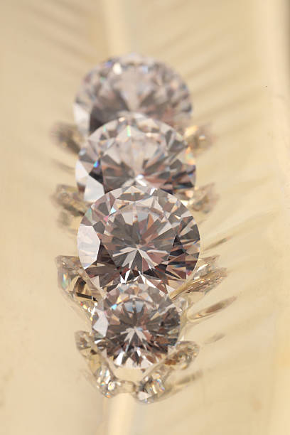 A piece of cut glass resembling a diamond backlighted yellow.