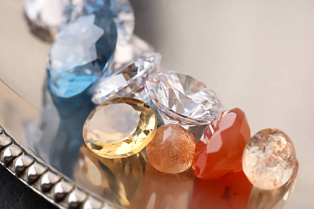 Beautiful shiny colorful gemstones on light background, closeup