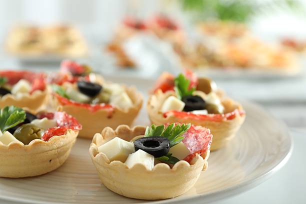 istock Many tasty canapes on white table, closeup 2244219129