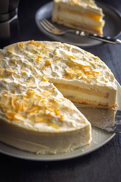 istock Sweet creamy cake on plate on black table. 2244219695