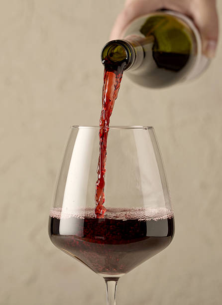 istock red wine pouring in glass 2244221545