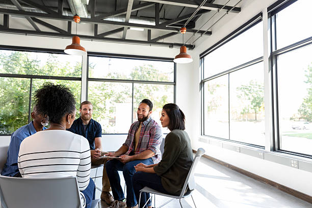 istock Diverse group engaged in supportive discussion and active listening during a meeting. 2244222517