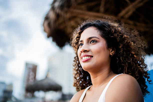istock Young woman looking at view on the beach 2244222660