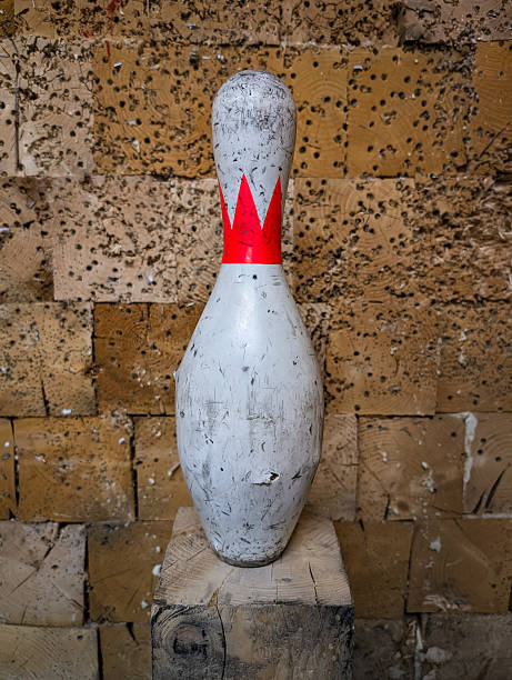 Black bowling ball and bowling pins on white background. Horizontal composition with copy space. Bowling concept.