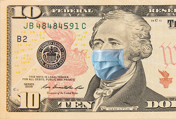 istock American dollar banknote with a face mask against infection. 2244222819